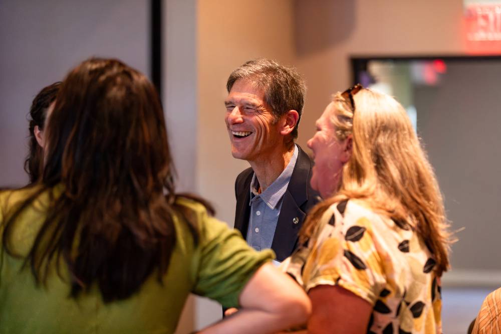 Al Steinman talking with other reception guests